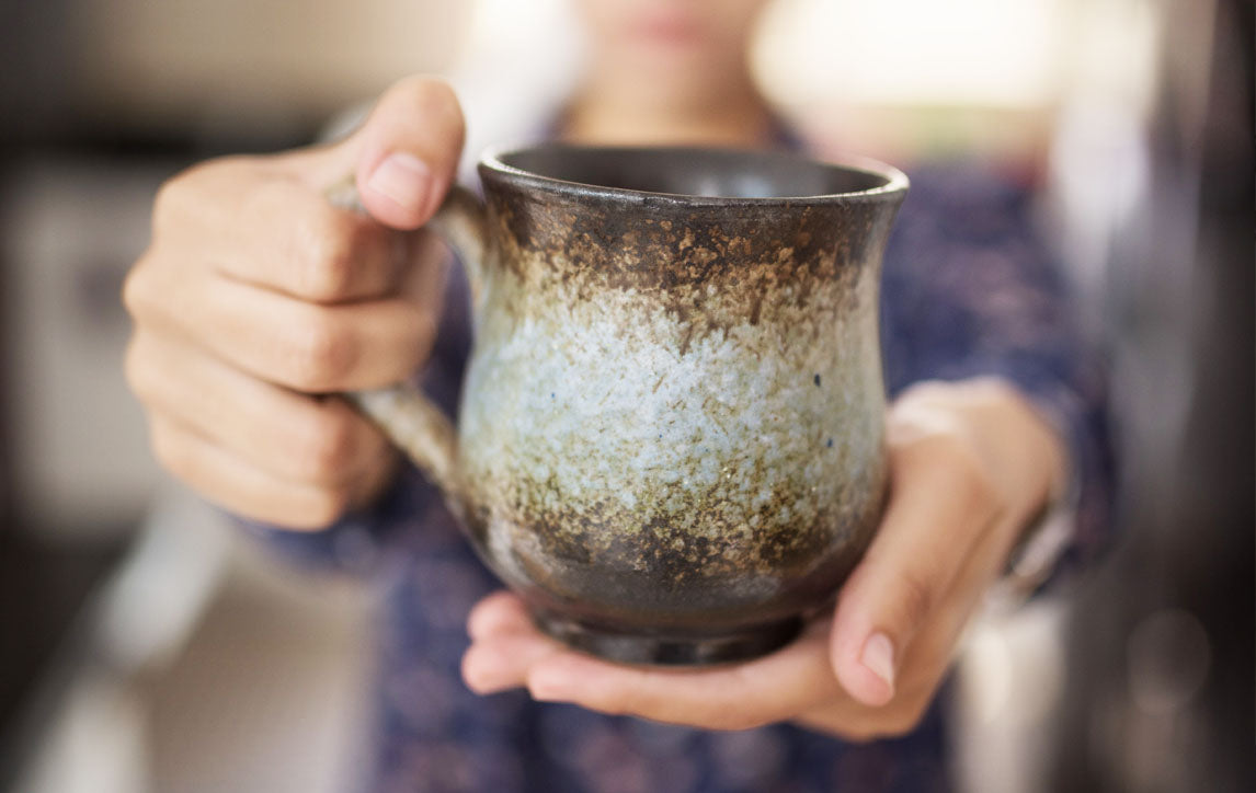 A Woman Holding a Ceramic Mug