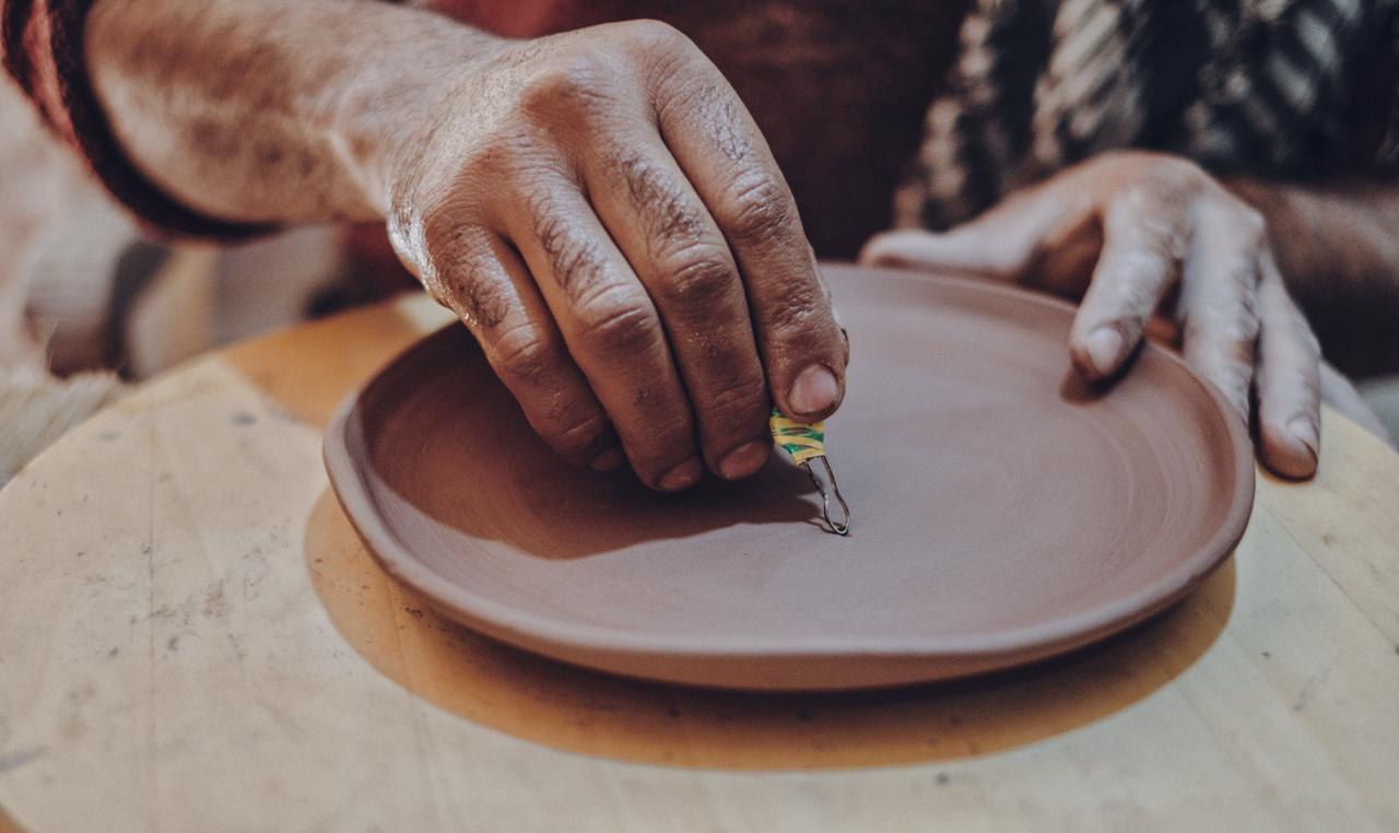 Craftsman Engraving a Ceramic Plate
