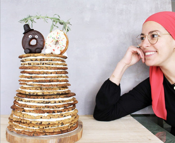 Ohoud Saad Staring at a Stack of Pies