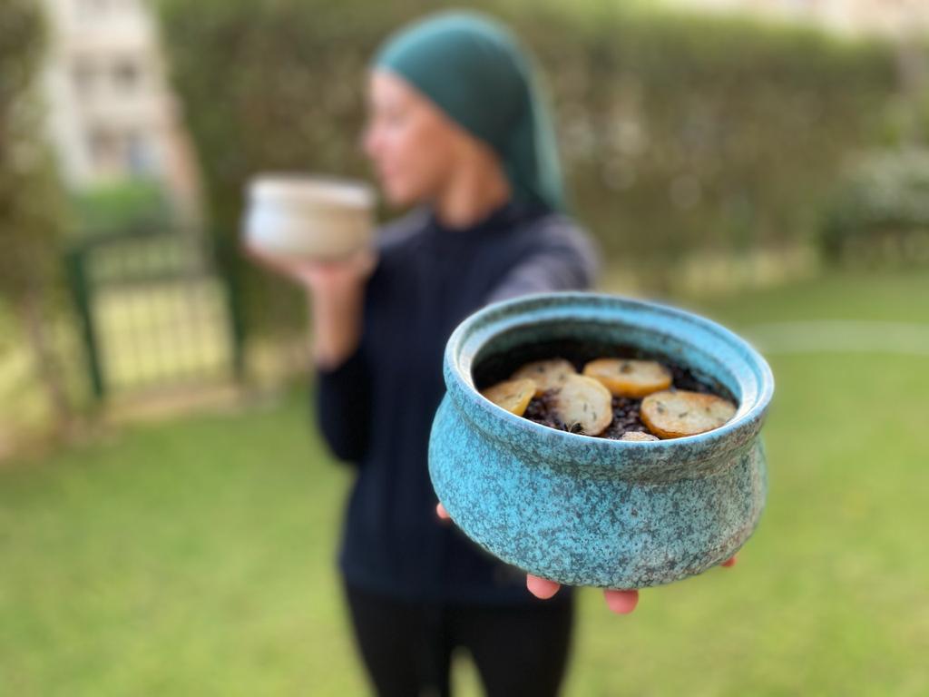 Ohoud Holding a Handmade Ceramic Pot
